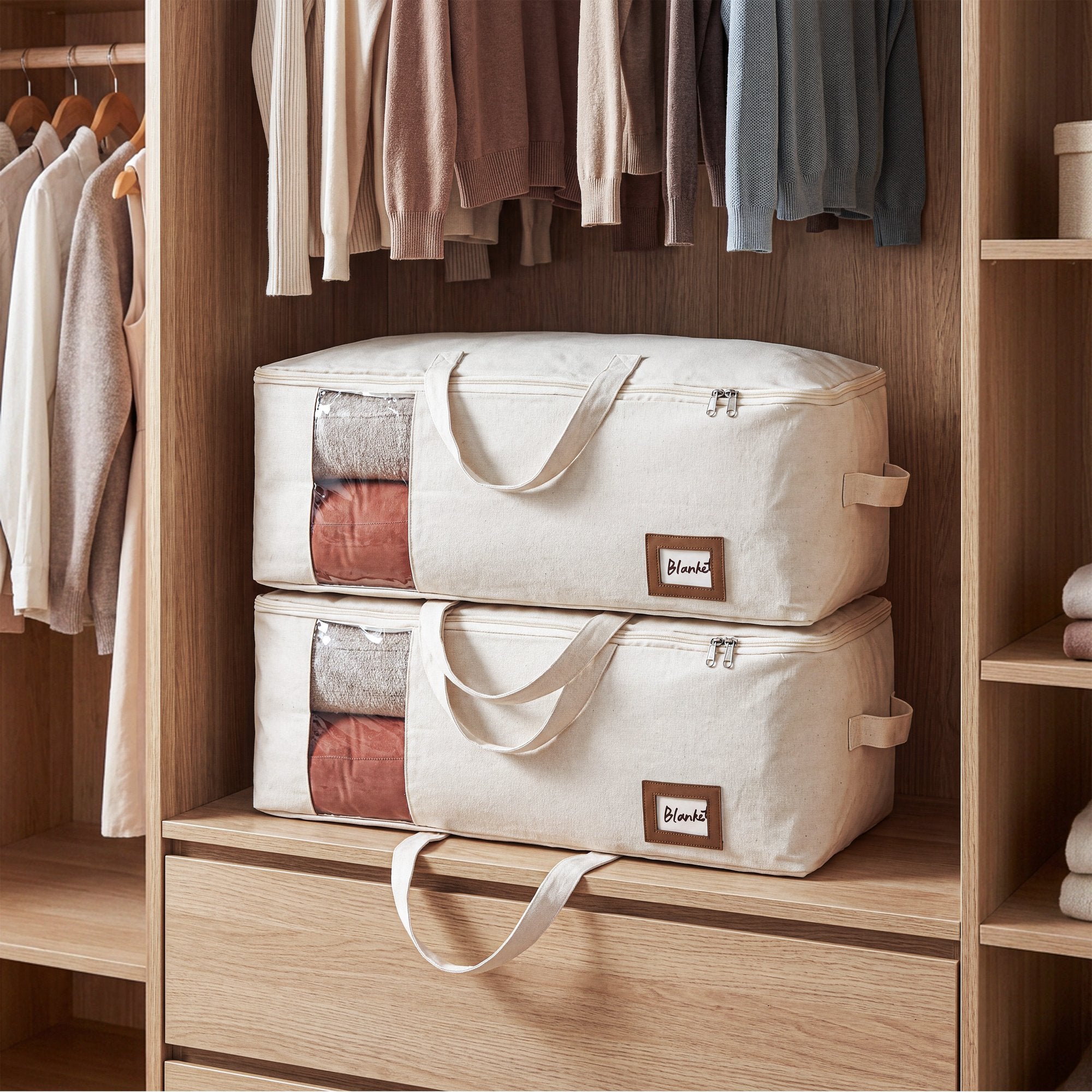 Cream canvas storage bags stacked on a wardrobe shelf