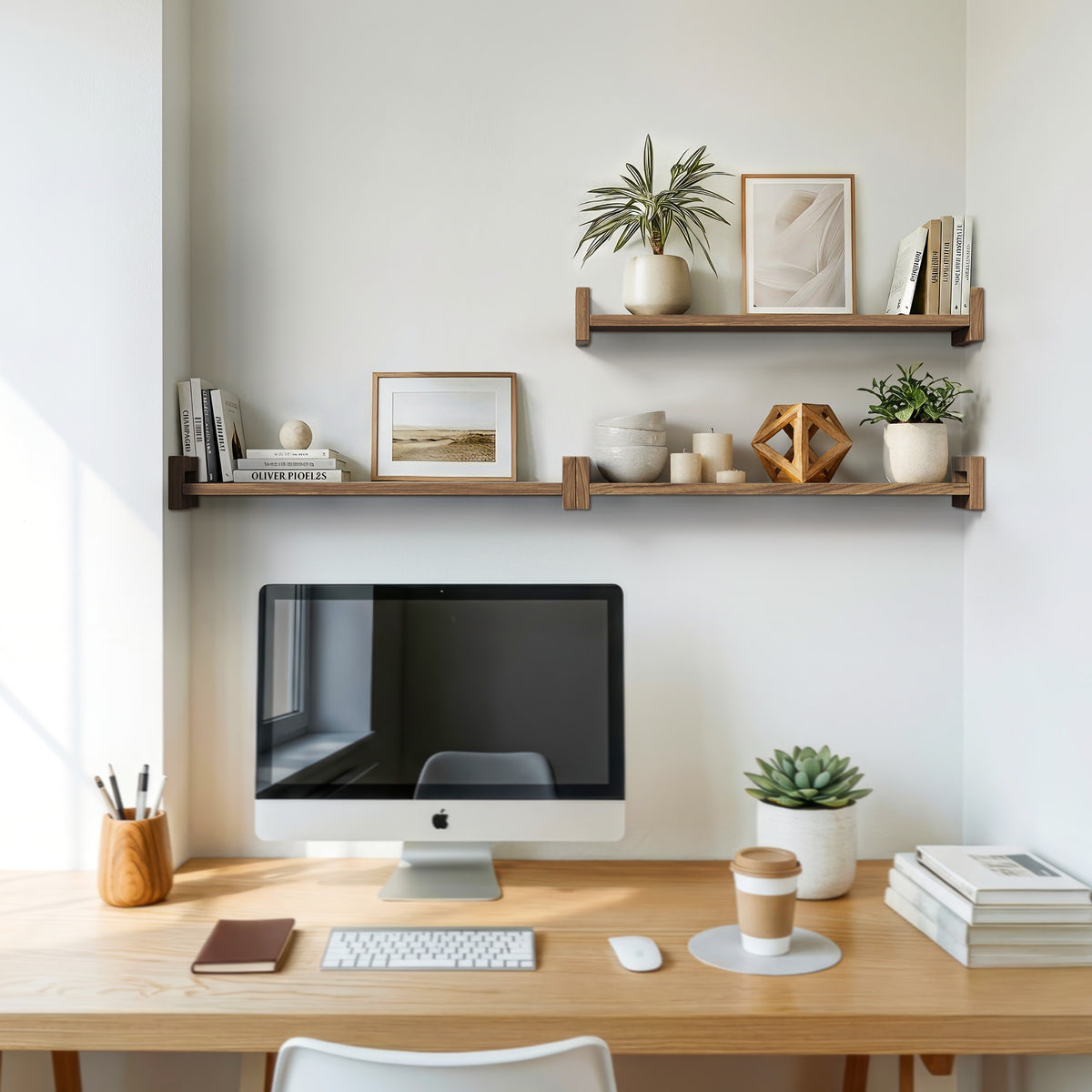 Floating shelves above a wooden desk with plants and framed prints