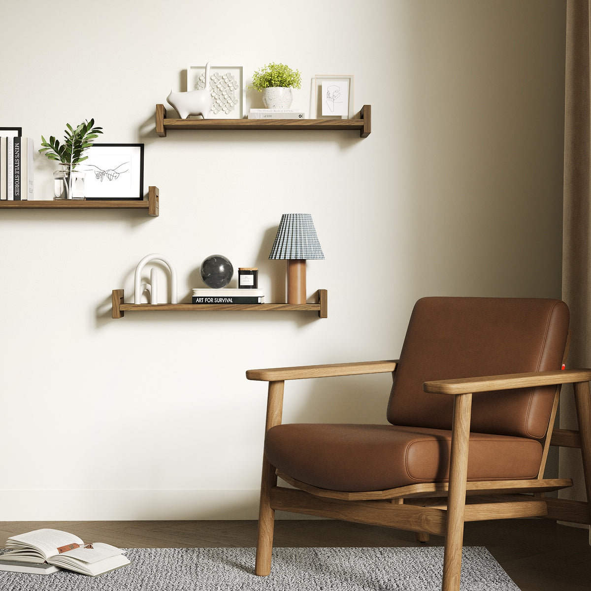 Floating shelves on a living room wall above a leather armchair